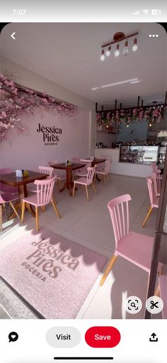 the interior of a restaurant with pink chairs