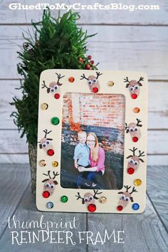 a wooden frame with reindeer antlers on it and a christmas tree in the background