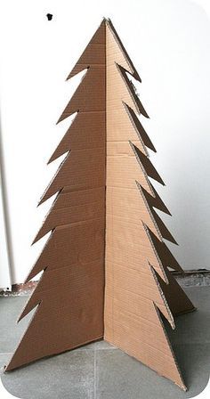 a cardboard christmas tree sitting on the floor