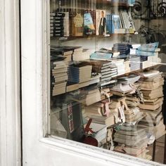 a bunch of books that are sitting in a window