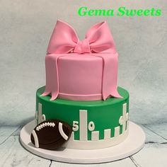 a cake with a football and bow on top that reads gena sweets 5 0