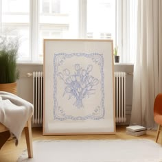 a white rug in front of a window with a blue drawing of flowers on it