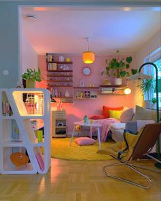 a living room filled with lots of furniture and decor on top of a hard wood floor