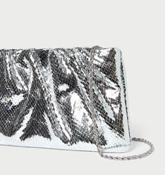 Gathered flat clutch in silver snake embossed leather. Features a removable metal chain strap, frame closure, full lining, and an interior metal logo plaque. DIMENSIONS W: 9.5" x H: 5.75"8.5" Strap Drop MATERIALS 100% Goat Leather PRODUCT CARE Keep away from water and avoid prolonged exposure to sunlight. Use a leather conditioner to maintain appearance. Heel Accessories, Loeffler Randall, Gold Light, Leather Conditioner, Goat Leather, Accessories Rings, Metallic Logo, Leather Clutch, Metal Chain