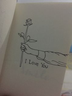 a drawing of a hand holding a flower with the words i love you written on it