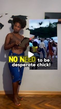 a woman standing in front of a wall with an ad on it that says no need to be desperate chick