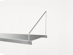 a metal shelf hanging from the side of a wall