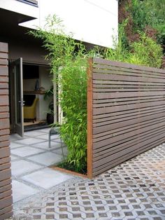 a wooden fence is in front of a house with a blue sign that says garden decoration