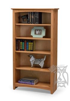 a wooden bookcase with three shelves and some books on the top one shelf has a dog figurine in front of it