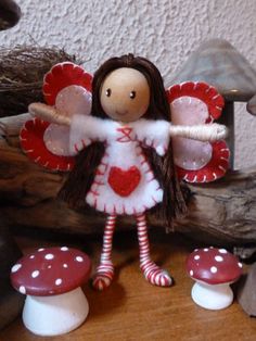 a doll is standing in front of mushrooms