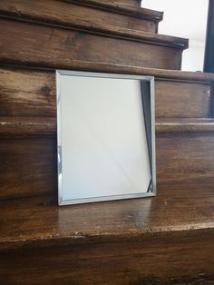 a mirror on the side of a wooden staircase