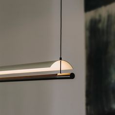 a modern light fixture hanging from the ceiling