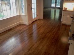 an empty living room with hard wood floors