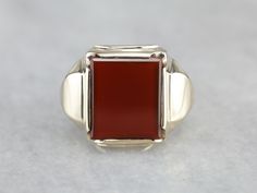 Simple and solid in size, this could be a great vintage piece! Dating to the mid-1900's, and the popular style continues to be a favorite decades later. The center of this ring is set with a deep, brick-red carnelian. Carnelian is traditionally a stone of courage, worn by leaders and heroes. Metal: 10K Yellow Gold Gem: Carnelian Gem Measurements: 11.3 x 14 mm, Rectangle Ring Size: 7.75 Marks: "HANDWROUGHT 10K" Stamped on the inside band Classic Carnelian Signet Ring For Formal Occasions, Classic Carnelian Signet Ring For Formal Events, Formal Carnelian Signet Ring With Polished Finish, Classic Carnelian Signet Ring With Polished Finish, Classic Red Signet Ring For Formal Occasions, Heirloom Red Signet Ring With Polished Finish, Classic Ruby Ring With Polished Finish For Collectors, Red Carnelian Signet Ring With Polished Finish, Formal Red Carnelian Signet Ring