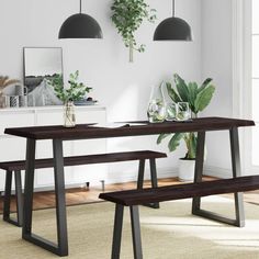 a dining table with two benches next to it