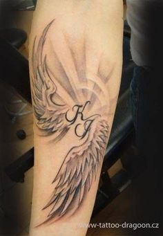 the arm with an angel tattoo on it, which is black and grey in color