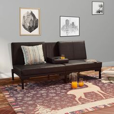 a living room filled with furniture and pictures on the wall