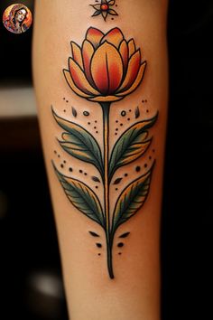 a woman's leg with an orange flower tattoo on the side of her leg