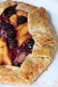 a close up of a pie with fruit on it