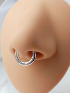 a close up of a fake nose with a ring on it