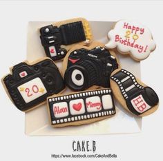 decorated cookies are arranged in the shape of cameras and film reels on a plate