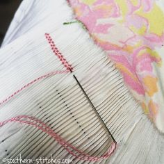 a close up of a piece of fabric with a needle on it