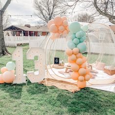 an outdoor party setup with balloons and letters