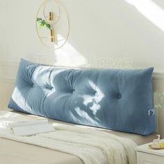 a bed with a blue pillow on top of it