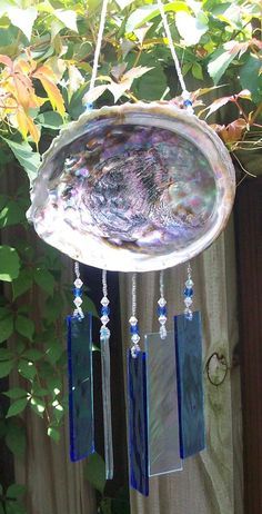 a wind chime hanging from a wooden fence