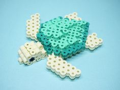 a close up of a lego turtle on a blue surface