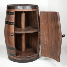 an old wooden barrel with two shelves next to it