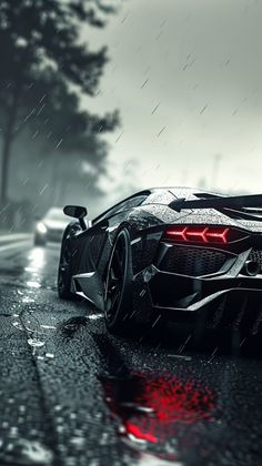 a black and white sports car driving on a wet road in the rain with red headlights