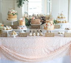 a table topped with lots of cakes and desserts