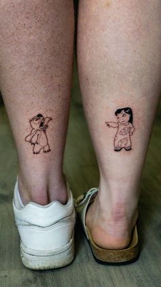 two people with small tattoos on their legs, one has a dog and the other has a cat