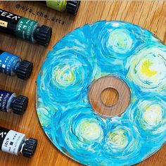 an art project made with acrylic paint and watercolors on a wooden table