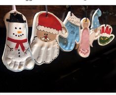 handprinted christmas ornaments hanging from clothes pins