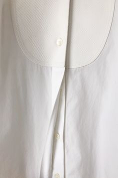 Celine White Tuxedo Shirt. White elbow sleeve tuxedo shirt with contrast pique woven bib and cuffs. Has pleat detail at sleeves. 100% Cotton, dry clean only. Marked as size 34, fits XS. Imported. Approx. Measurements: Underarm to Underarm: 17" Length: 22" Classic Summer Blouse With Fold Down Collar, Classic Shirt With Cuffed Sleeves And Collar, Classic Tops With Cuffed Sleeves And Collar, Classic Blouse With Collar And Concealed Placket, Classic Tops With Fold Down Collar For Daywear, Classic Collared Tops For Daywear, Classic Top With Fold Down Collar For Daywear, White Tops With Detachable Collar For Workwear, White Top With Detachable Collar For Workwear