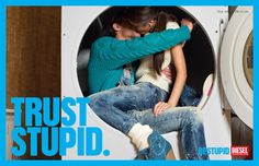 a woman sitting in a washing machine with her arm around the man's head