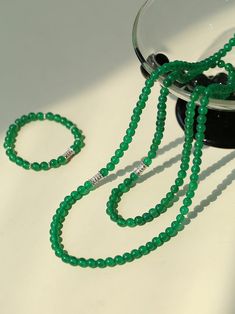 This elastic necklace combines traditional Chinese aesthetic elements with modern style. Featuring sparkling zirconia beads and soothing green agate beads, this necklace exudes elegance and sophistication. The intricate bead arrangement creates a harmonious balance between vintage charm and modern style. Metal: Recycled Sterling Silver Gemstone: Cubic Zirconia,Green Onyx Diameter: Long 760mm,Short 440mm Weight: Long 42g,Short 24g Elegant Green Beaded Necklaces With Polished Beads, Elegant Jade Beads As Gift, Elegant Green Jade Crystal Necklace, Elegant Jade Crystal Necklaces With Round Beads, Elegant Green Onyx Beaded Necklaces, Elegant Beaded Jade Crystal Necklaces, Elegant Jade Gemstone Beads, Elegant Jade Crystal Necklace With Round Beads, Elegant Silver Jade Beaded Necklace