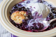 a bowl filled with blueberry cobbler and ice cream