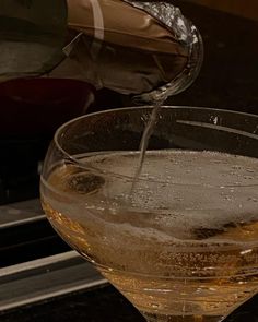 a glass filled with liquid sitting on top of a stove