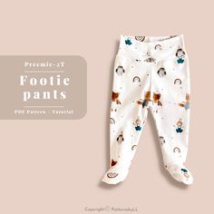 a baby's footie pants with dogs and rainbows on it, against a pink background