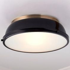 a close up of a light fixture in a room with white walls and flooring