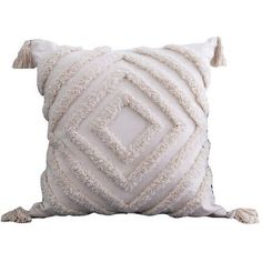 a white pillow with tassels on it