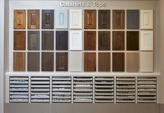 the cabinets and doors are all different colors in this display case, which is also labeled cabinet & tops