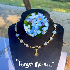 Show off with this elegant necklace! This necklace, inspired by the flower forget-me-not, is perfect for you and a perfect gift for someone you love! The stunning gold wire and blue beads are perfect for anyone. Handcrafted with glass beads, this necklace will add a stunning flair to any outfit and will enhance your wardrobe. Length- This necklace is 15 inches long, but size can be changed if necessary, just leave a note :) Cheap Handmade Blue Flower Necklace, Flower Wire, Decatur Ga, Necklace Flower, Wire Necklace, Elegant Necklace, Pretty Necklaces, Crystal Flower, Elegant Necklaces