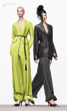 two women in black and green outfits standing next to each other