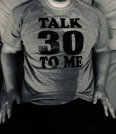 a man wearing a t - shirt that says talk 30 to me