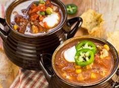 two bowls of chili and corn soup on a table