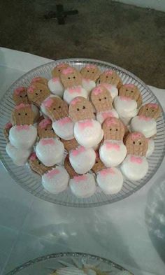 there is a plate full of cookies and marshmallows on the table next to each other